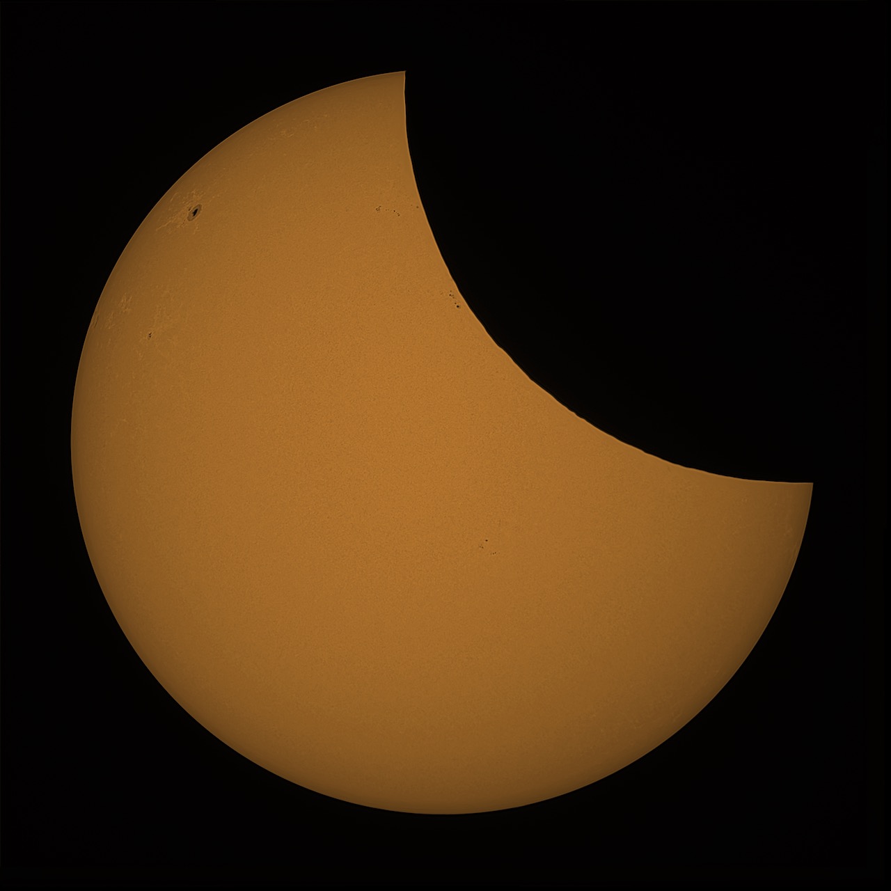 Partial solar eclipse showing the Moon covering part of the Sun's disk.